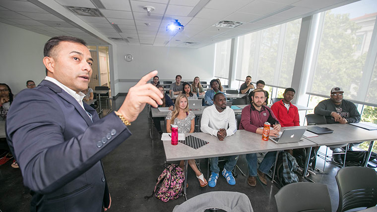 Dr. Albert Barreda gives a lecture to his hospitality class.